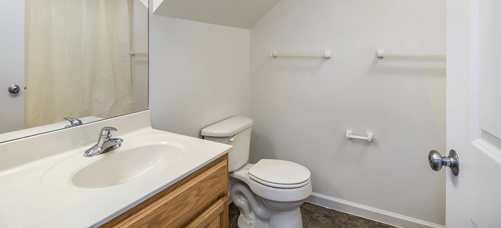 an empty bathroom with a toilet and a sink