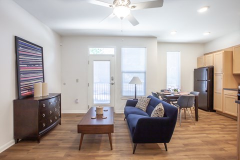 A living room with a blue couch and a wooden coffee table.