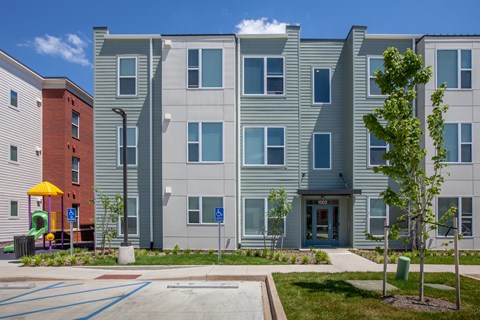 Parking lot, playground, and landscaping in front of apartment buildings-Beecher Terrace, Louisville, KY