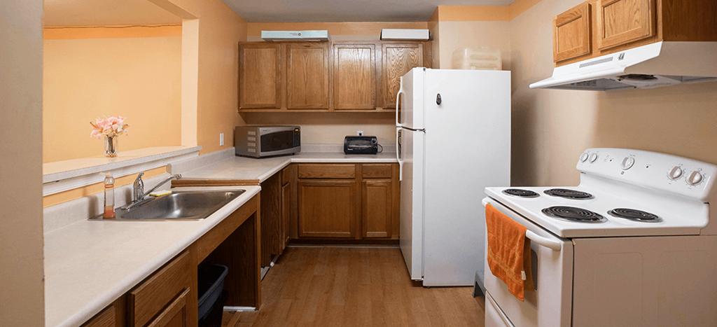 Kitchen a kitchen with a stove refrigerator and a sink