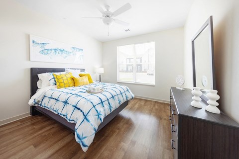 a bedroom with a bed and a ceiling fan