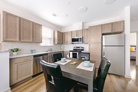 a kitchen with stainless steel appliances and a wooden table