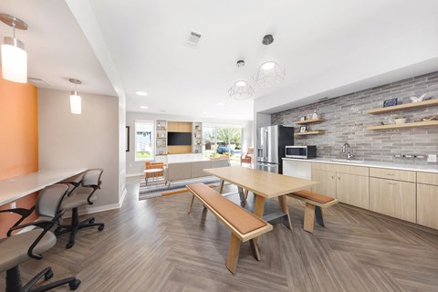 a dining room and kitchen with a table and chairs