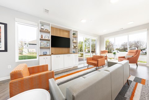 a living room with couches and chairs and a television