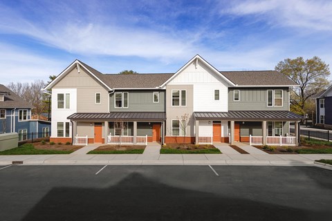 the view of a house with a street in front of it