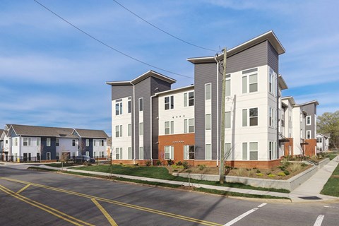 a row of apartment buildings on the side of a street
