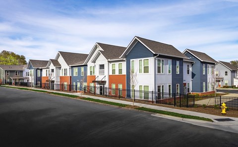 a row of colorful houses on the side of a street
