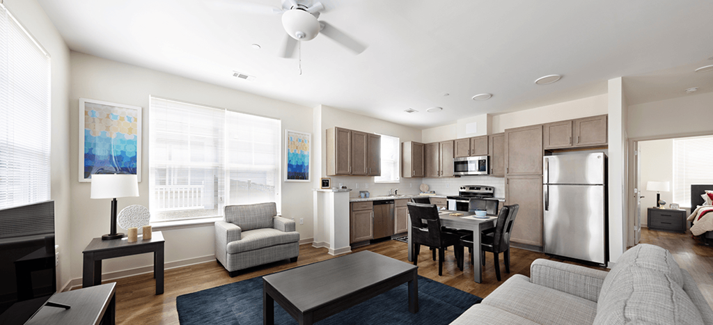an apartment living room with a kitchen and a dining room
