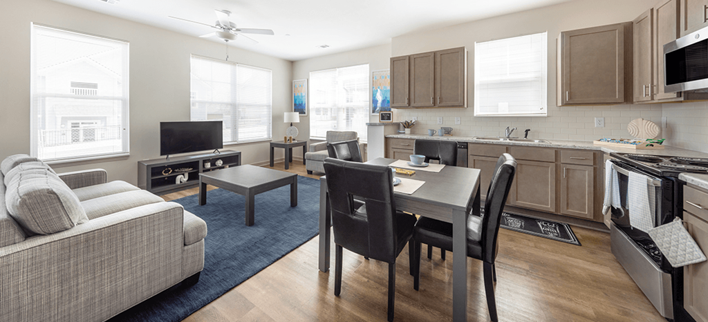 a living room and dining room with a couch and a table at Brown School Lofts