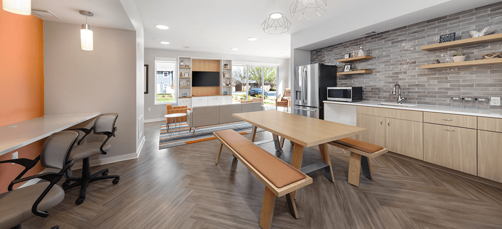 a kitchen and dining room with a table and chairs