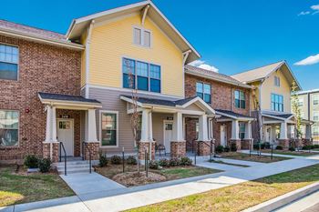 A row of houses with a clear blue sky above them.