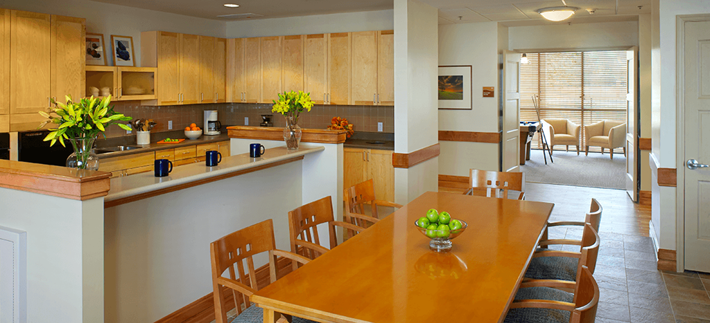 a kitchen and dining room with a wooden table and chairs