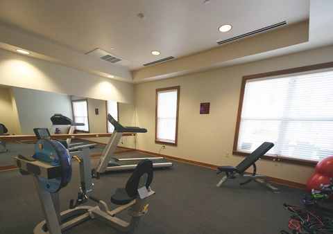 a workout room with exercise equipment at Cambridge Senior Living