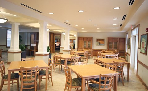 a large dining room with tables and chairs at Cambridge Senior Living