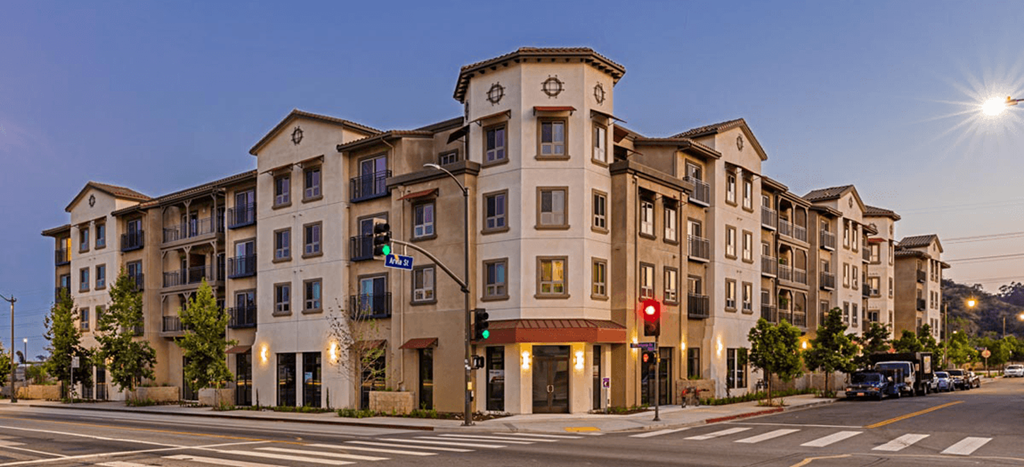 Casa Salazar apartment building on the corner of a street at dusk
