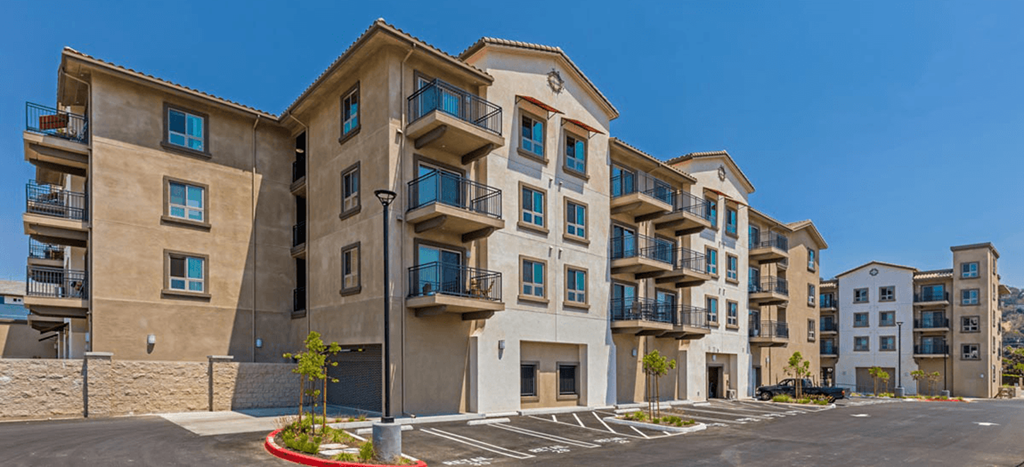 a row of apartment buildings with balconies and a parking lot at Casa Salazar