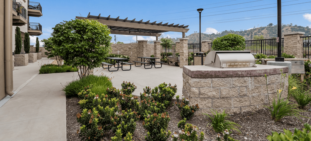a patio with a grill and a table and benches at Casa Salazar Apartments