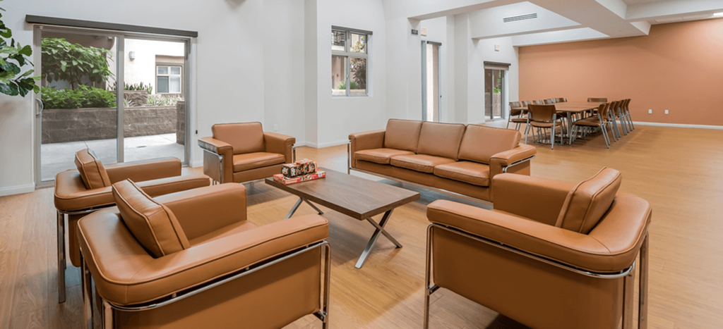 Casa Salazar clubhouse with leather couches and chairs and a table