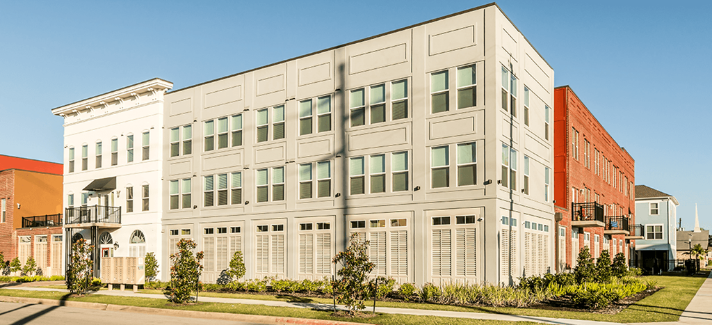 a large apartment building with a street in front of it