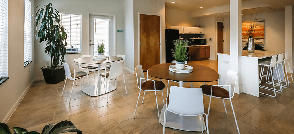 Cedars at Carver Park clubhouse with a table and chairs and a kitchen