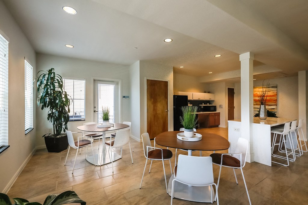 a dining room and kitchen with a table and chairs