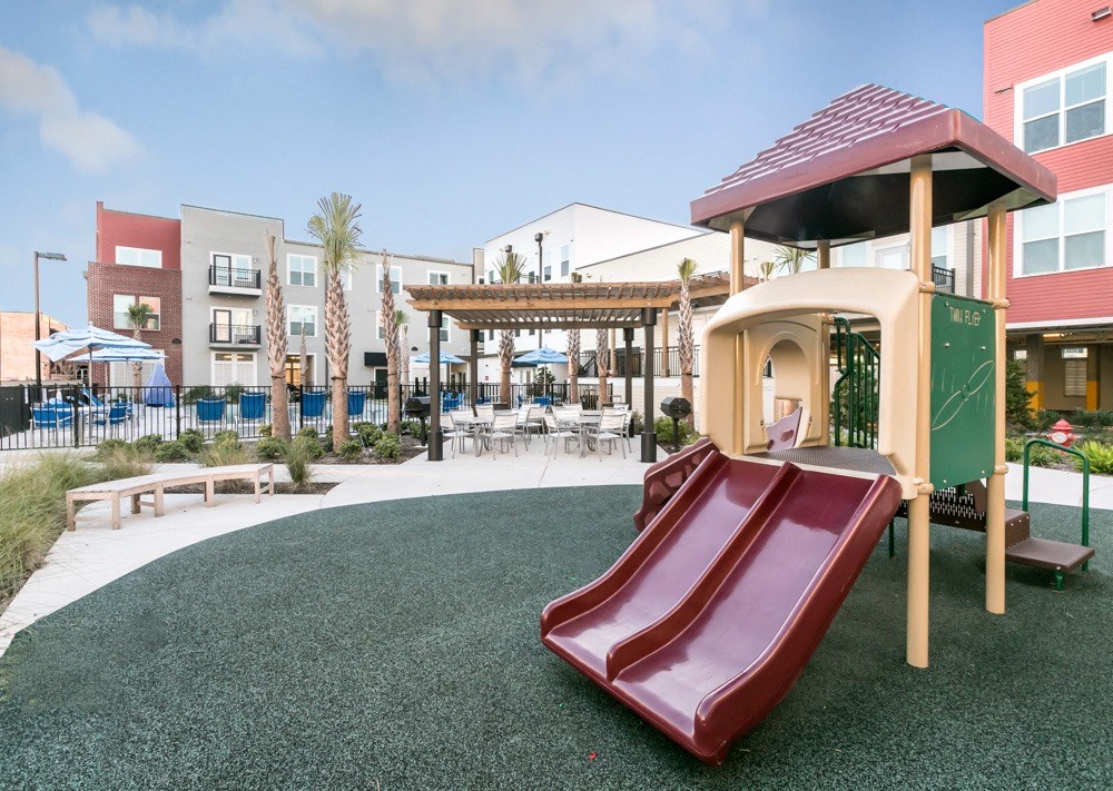 a playground with a slide and a gazebo