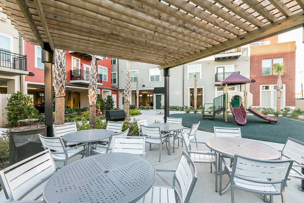 an outdoor patio with tables and chairs at the yards