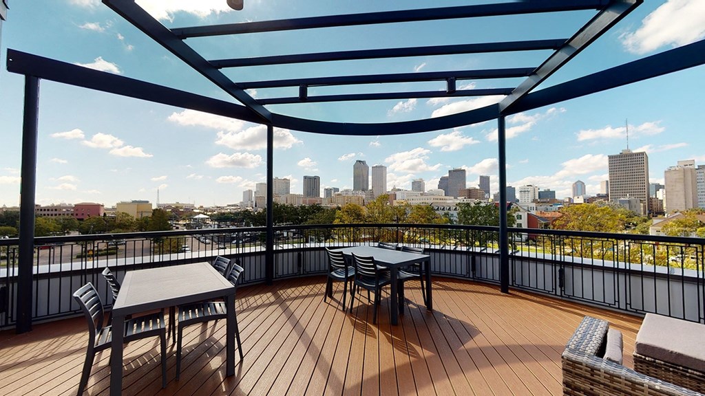 a balcony with a view of a city and a table and chairs at City Square 162