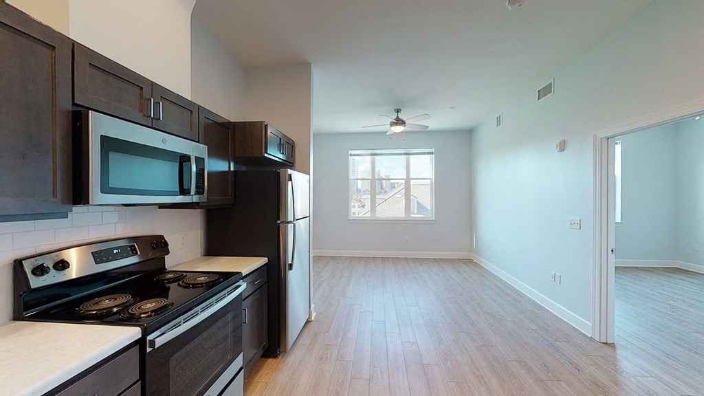 an empty kitchen with a stove and a refrigerator at City Square 162