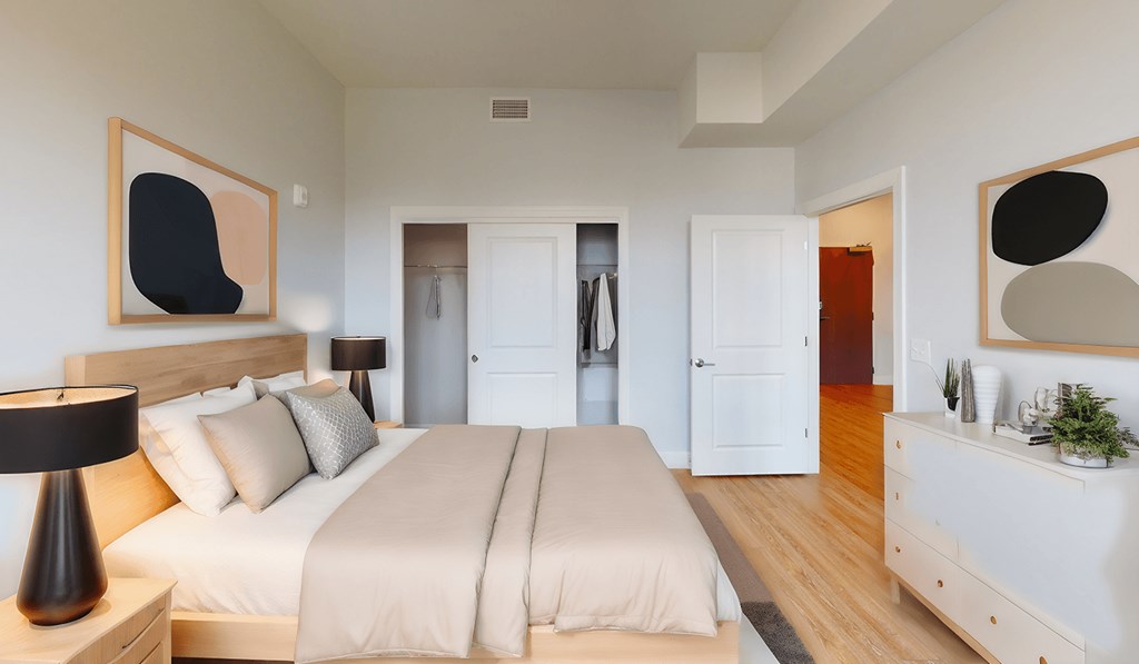 a bedroom with a bed and a dresser and a closet at City Square 162