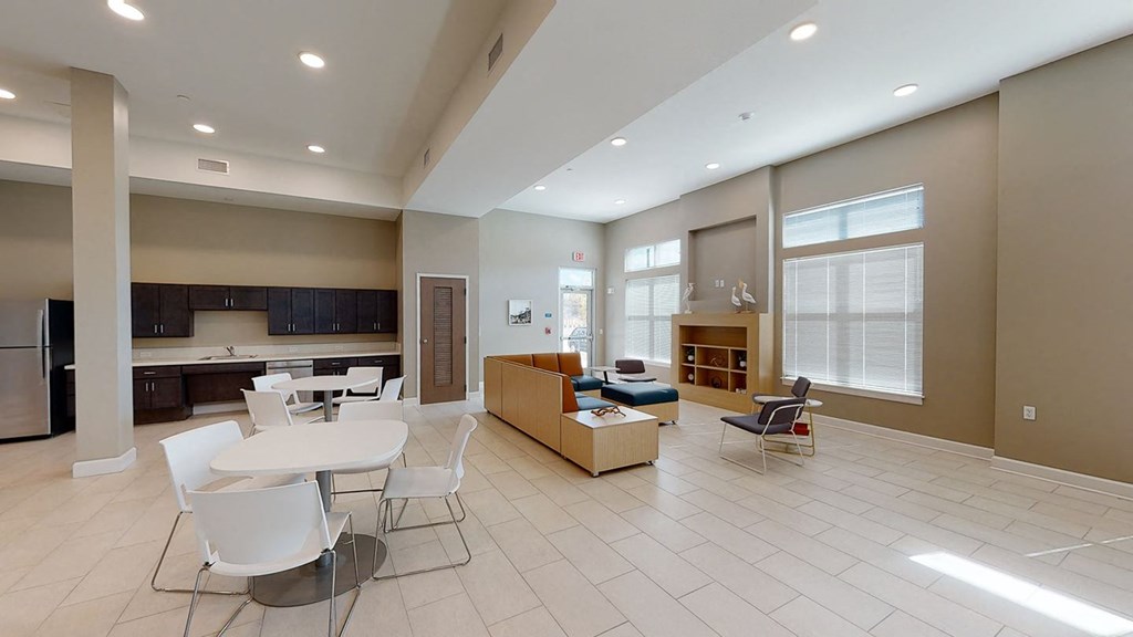 a community room and kitchenette with tables and chairs at City Square 162