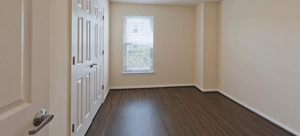 an empty room with a door and a window