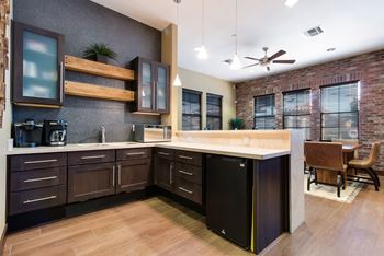 A kitchen with dark wood cabinets and a white countertop.