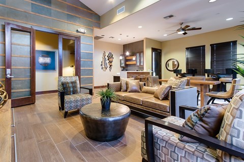 A living room with a brown coffee table and a brown couch.