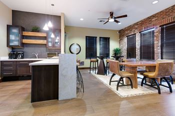 A kitchen with a dining table and chairs.