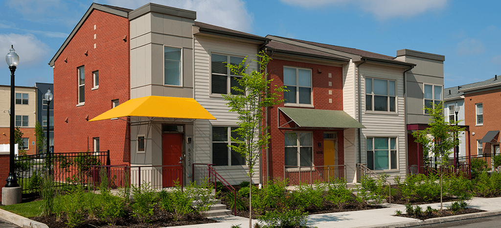 a row of town houses with a yellow awning in front of them