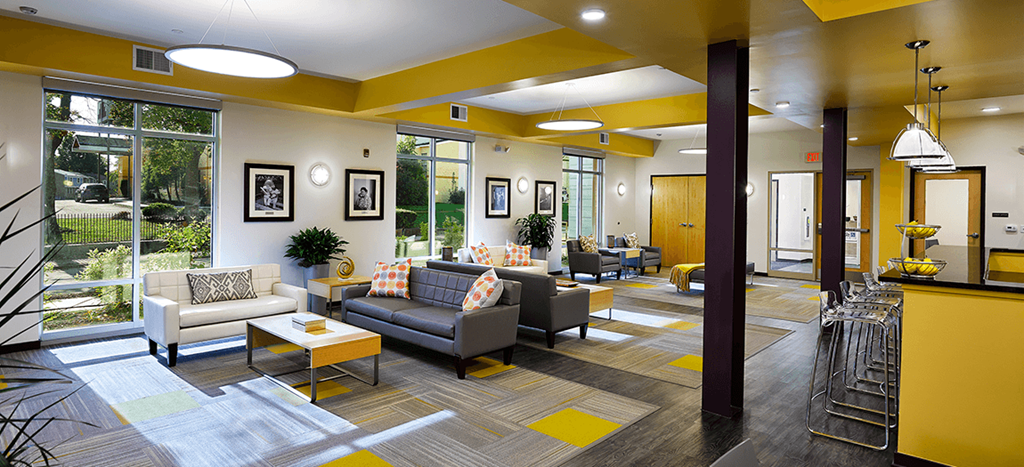 a lobby with couches and chairs and a large window