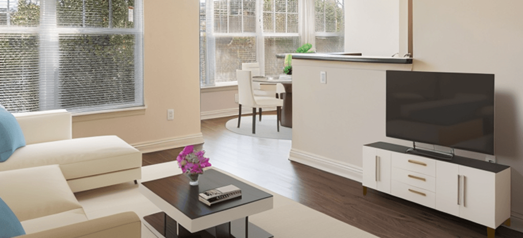 a living room with a couch and a table and a television at Crawford Square Apartments