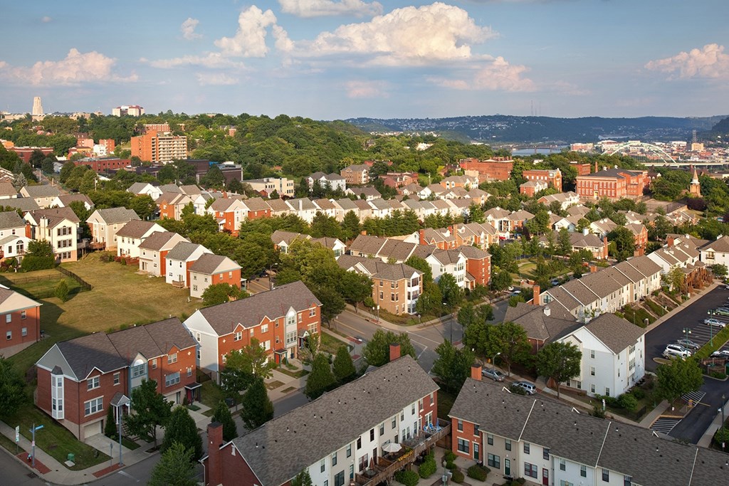 an aerial view of a neighborhood with houses and trees at Crawford Square Apartments & Townhomes