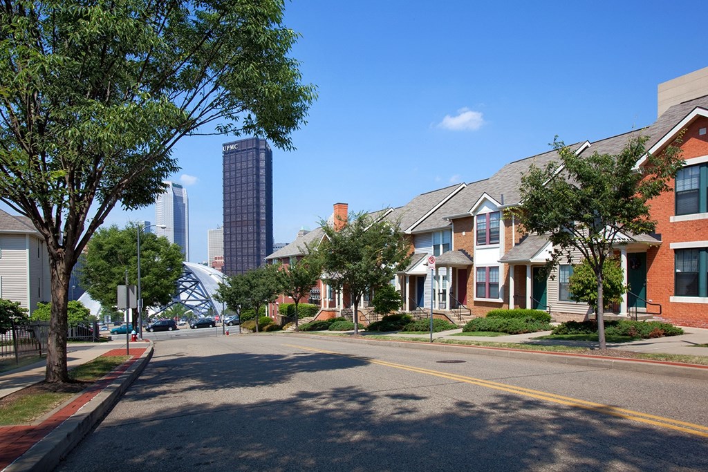 a view of a street with buildings and trees at Crawford Square Apartments & Townhomes