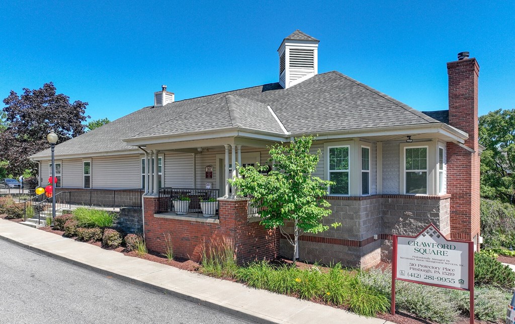 Leasing office with a sign in front of it at Crawford Square Apartments & Townhomes