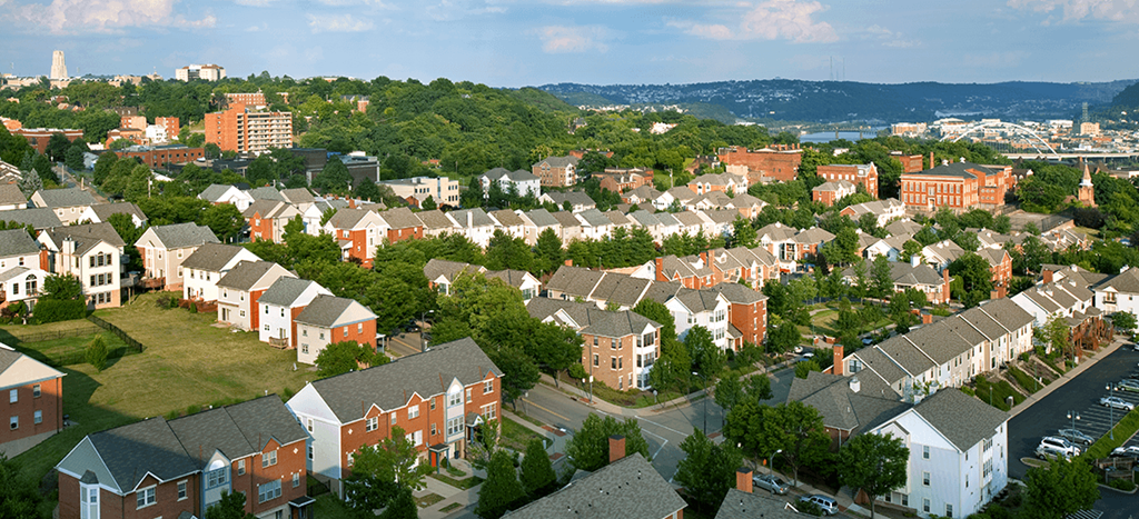 an aerial view of a neighborhood with rows of apartment homes