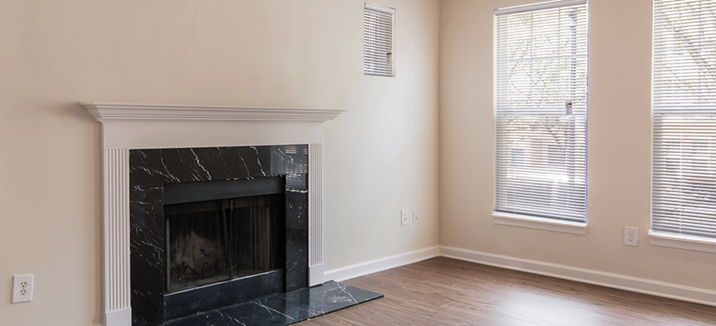 a living room with a fireplace and a wooden floor