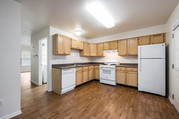 Kitchen with white appliances at Duneland Village apartments and townhomes in Gary, IN