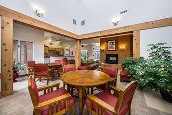 a living room with a table and chairs and a fireplace