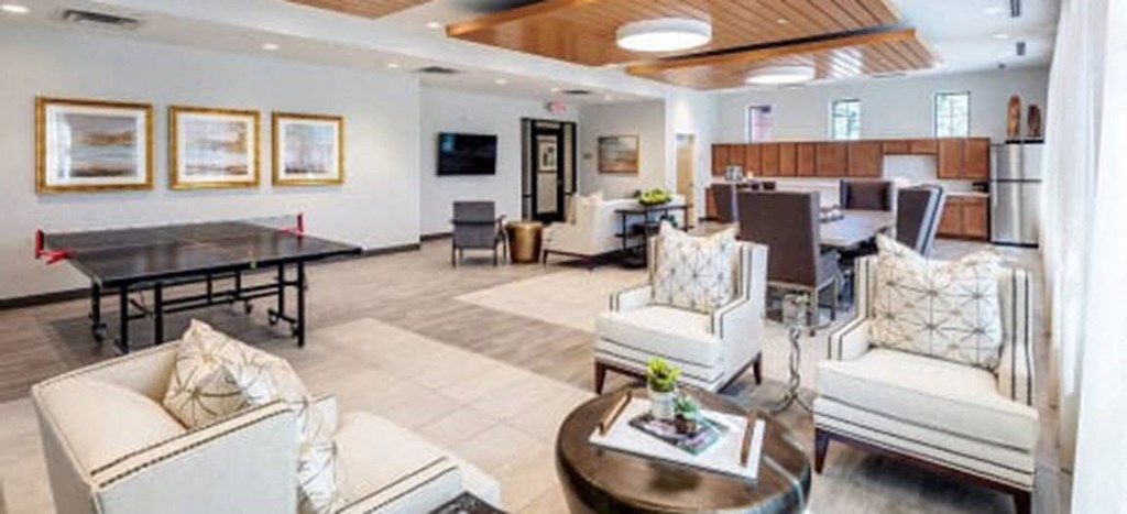 a living room and dining room with a table and chairs