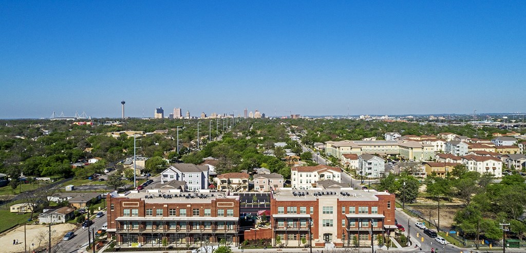 an aerial view of the city with buildings and trees at East Meadows Apartments