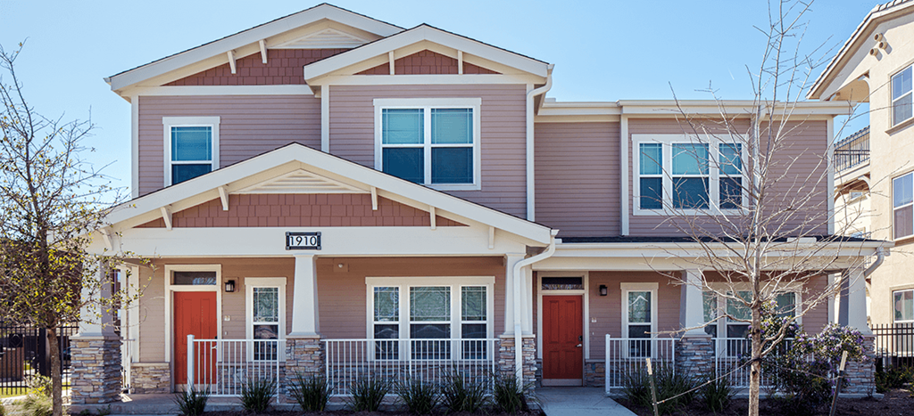 an apartment home with a red door and a porch