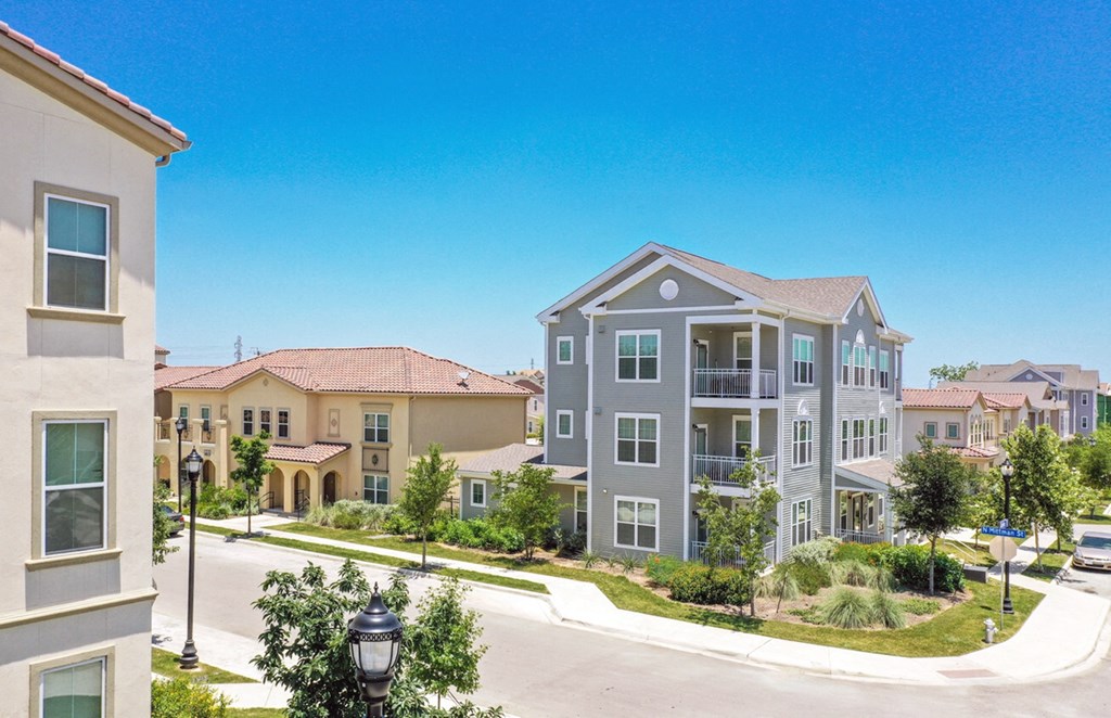a row of town houses on a street with a street light at East Meadows apartments in San Antonio, TX