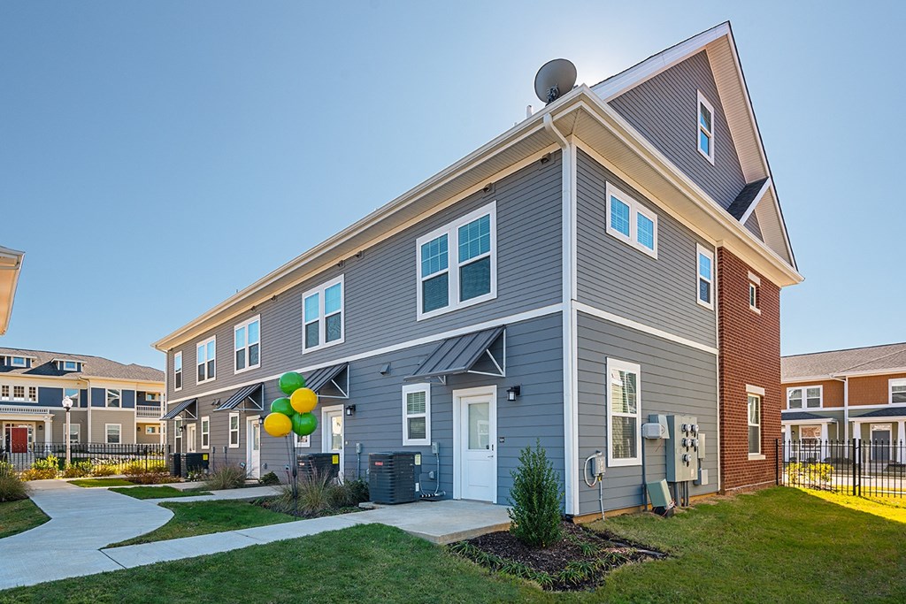 an apartment building with balloons in front of it